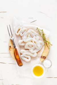 sliced raw squid rings with lime, olive oil, breadcrumbs. Preparation of Summer healthy snacks